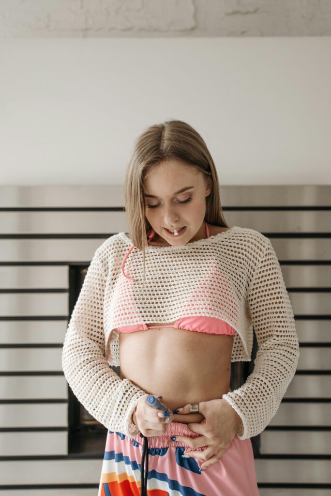 Does Ozempic Affect Fertility? Everything You Need to Know (2026) Young woman administering insulin injection, showcasing diabetes management indoors.